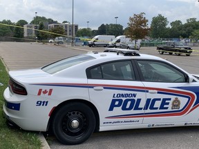 London police investigating a Sunday-morning homicide in east London converged on the parking lot of the Home Depot on Dundas Street at Clarke Road, where officers were seen collecting items and taking photographs. DEREK RUTTAN/The London Free Press)