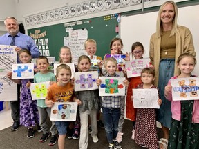 A pilot program letting Low German-speaking Mennonite pupils learn in their own language and culture is gaining traction at Straffordville elementary school, where principal Tim Coombs and teacher Jessica Dyck join pupils, back row from left, Lisa Neufeld, Ajay Klassen, Anna Peters, Keegan Teichroeb, Lynnda Klassen, Susy Hiebert and, front row, Aiden Teichroeb, Katherine Klassen, Aby Hiebert, Margaret Neufeld and Annie Neufeld.  (Heather Rivers/The London Free Press)