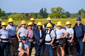 Some of the 19 people taking part in a training program in new building technologies pose for a photograph at the groundbreaking ceremony for two micro-homes they are helping to build in Chippewas for the Thames First Nation.  Photo taken Tuesday September 20, 2022. (Calvi Leon/The London Free Press)