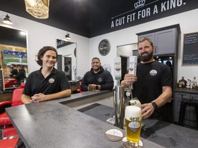 4EST Brewing's Colin Gunn, left, and Richard Gonzalzes are on hand as Myles Rombough, of 4EST Brewing, pulls a lager on tap at Gonzalez's King's Blades barbershop which he co-owns in London's West 5 area. (MIKE HENSEN/The London Free Press)
