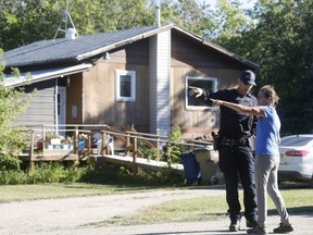 Ruby Works, a friend of Wes Petterson, speaks to a Royal Canadian Mounted Police officer outside Petterson's home in Weldon, Saskatchewan, Canada, on September 6, 2022. Petterson has been identified as one of the stabbing victims. (Photo by LARS HAGBERG/AFP via Getty Images)