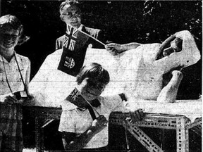 This grainy image is a reproduction of a page in the July 3, 1959 edition of The London Free Press. It shows 13-year-old Bobby Baldwin, in a full-body cast, waving a flag toward Queen Elizabeth as she visited the Forest City.