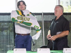 With head coach Dale Hunter by his side, Sam Dickinson puts on a Knights sweater with the number three at a news conference  in London on Thursday, Sept. 1, 2022. (Derek Ruttan/The London Free Press)