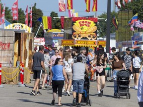 People walk the midway on opening day of the Western Fair in London on Friday September 9, 2022. (Derek Ruttan/The London Free Press)