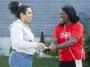 Mayoral candidate Sandie Thomas, right, speaks with Alexys Cassanova while campaigning in London, on Wednesday Sept. 14, 2022. (Derek Ruttan/The London Free Press)