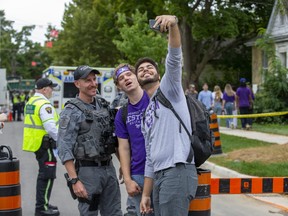 Police were treated like celebrities when thousands of students gathered on Broughdale Avenue during Western University's Homecoming weekend in London on Saturday September 24, 2022. Derek Ruttan/The London Free Press/Postmedia Network