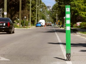 A flexible marker marks the position of speed bumps and keeps motorists from veering into the bike lane to avoid them in London, Ont.  (Free Press file photo)