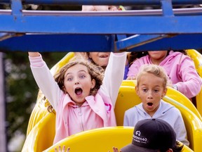 Friends Ayah Habash, 7, and Aliya Simmonds, 7 have quite different reactions to the Caterpillar ride at the Western Fair  on Monday September 12, 2022. Mike Hensen/The London Free Press/Postmedia Network