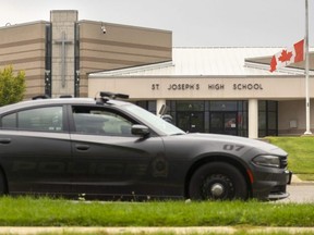 St. Thomas Police sit outside St. Joseph's Catholic high school after a bomb threat shuttered the school and St. Thomas Aquinas in London on Tuesday September 13, 2022.  (Mike Hensen/The London Free Press)