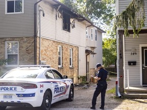Police and fire officials were on the scene of an overnight fire at 153 Sydenham St. in London on Friday Sept. 16, 2022. 
The fire, the damage from which is clear in a second-storey window, has been deemed suspicious. (Mike Hensen/The London Free Press)