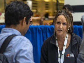 Timberland Equipment's Melissa Atkinson speaks to job seekers at a job fair on Tuesday September 20, 2022 at White Oaks Mall sponsored by the London Economic Development Corp.  Mike Hensen/The London Free Press