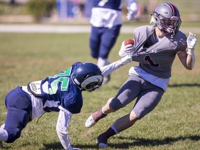 Laurier's Lucan Clewlow can't hold on to South running back Noah Amaral in a Thames Valley Central senior boys game Friday, Sept. 23, 2022, at Laurier. The Rams won the season opener for both teams 27-14. (Mike Hensen/The London Free Press)