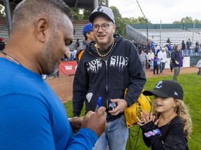 Kane Gibson and his daughter Daisy, 7 get Majors manager/owner Roop Chanderdaat to sign a baseball at Labatt Park in London, Ont. 
Photograph taken on Friday September 23, 2022. 
Mike Hensen/The London Free Press/Postmedia Network