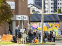 People queue outside First Baptist Church in the Park on Richmond Row for a dinner provided by the Ark Aid Street Mission on Monday September 26, 2022.  (Mike Hensen/The London Free Press)