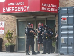Toronto police officers gather at the emergency entrance at the rear of Sunnybrook hospital on Monday, Sept. 12, 2022. A Toronto police officer was shot and killed in Peel Region. (Jack Boland/Postmedia Network)