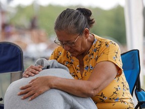 Annie Sanderson comforts her granddaughter, who was close with Gloria Lydia Burns, 62, who was killed on James Smith Cree Nation after a stabbing spree killed 11 people on the reserve and nearby town of Weldon, Saskatchewan, Canada. Sept. 5.