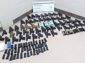 This photo from the Canada Border Services Agency shows 56 prohibited firearms allegedly seized Nov. 1, 2021 at the Blue Water Bridge in Point Edward. (Canada Border Services Agency)