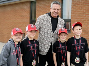 NHL legend Doug Gilmour poses with a group of young fans. (Mark Malone/ Postmedia)