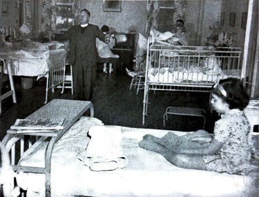 Canon Alfred Abraham is shown along with a patient in this 1949 photo. Supplied