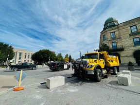 A municipal salt truck and concrete blocks barricade South Street, leading to Goderich's main square, on Oct. 1, 2022 as the town braces for a rumoured unsanctioned car rally. (Kathleen Smith/Goderich Signal Star)