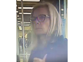 London police are asking the public for help identifying a suspect after a woman spat at and hurled racist comments at a person inside a northwest London business. (Police photo)