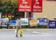 Election signs on the corner of Oxford Street and Adelaide Street in London, Ont. on Monday, Oct. 17, 2022. had to be removed by 12:01 a.m. Thursday morning, according to the city's election sign bylaws. (Derek Ruttan/The London Free Press)