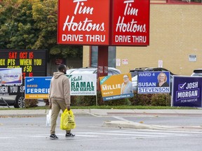 Election signs on the corner of Oxford Street and Adelaide Street in London, Ont. on Monday, Oct. 17, 2022. had to be removed by 12:01 a.m. Thursday morning, according to the city's election sign bylaws. (Derek Ruttan/The London Free Press)