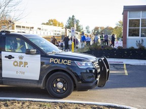 Parents collect their children from River Heights elementary school in Dorchester at 5 p.m. on Thursday, Oct. 27, 2022 after police arrested three suspects in an armed robbery and a lockdown was lifted.  (Derek Ruttan/The London Free Press)