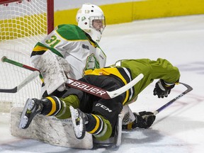 Liam Arnsby of the North Bay Battalion falls on London Knights goalie Zach Bowen during their game at Budweiser Gardens in London on Friday Oct. 28, 2022. North Bay won, 4-3. Derek Ruttan/The London Free Press