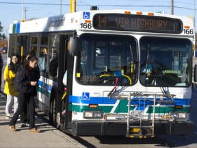 Riders climb aboard a London Transit bus