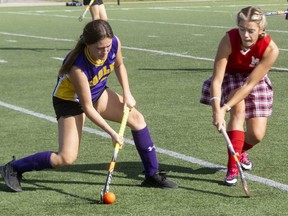 East Elgin's Isabella Reed fires a pass with Medway's Ella Caponcini trying to get a stick on it to block during their Thames Valley girls field hockey game at City Wide Fields in London on Thursday, Oct. 6, 2022. Medway pulled out a 2-0 win on two goals by Jocelyn Amos.  (Mike Hensen/The London Free Press)