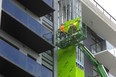 Edgar Quesda and Cesar Escobar of Titan Construction attach a form of drywall before the cladding is installed at York Developments ParkVu tower at the corner of Wonderland Road and Springbank Drive in London on Oct. 7, 2022. (Mike Hensen/The London Free Press)