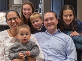 London mayoral candidate Josh Morgan and his wife Melanie are surrounded by their children Archer, 1, McKenna, 11, Max, 6, and oldest daughter Ainsley, 14, at their London home. Photo shot on Friday, Oct. 7, 2022. (Mike Hensen/The London Free Press)