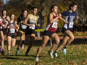 Catholic Central's Paige Marchant and South Collegiate's Kaitlyn Koyanagi start to open a gap early in the senior girls six-kilometre race at the WOSSAA cross-country championships, held in Springbank Park in London on Thursday Oct. 27, 2022. (Mike Hensen/The London Free Press)