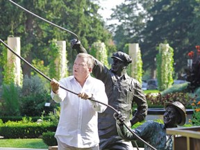 Actor William Shatner pretends to tug on the rope of the tent-raising statue next to the Festival Theatre in Stratford during a break from filming his documentary The Captains in 2010. (Postmedia Network file photo)