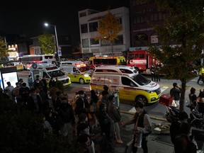 Ambulances carrying victims head to the hospital near the scene in Seoul, South Korea, Sunday, Oct. 30, 2022.&ampnbsp;Global Affairs says a Canadian was injured in a crowd surge that killed more than 150 people in Seoul, South Korea.