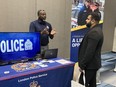 London police Sgt. Al Pierre, recruiting outreach officer, speaks with one of the attendees at the London Newcomer Day event held on Saturday Oct. 29, 2022 at RBC Place. This year's event drew more than 400 attendees and attracted more than 50 employers and support service organizations. (Jennifer Bieman/The London Free Press)