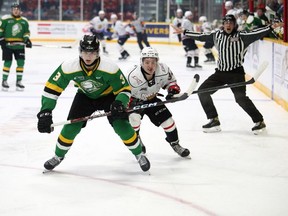 Sam Dickinson of the London Knights and Thomas Chafe of the Owen Sound Attack race for the puck in the first period of their OHL game at the Harry Lumley Bayshore Community Centre on Wednesday, Oct. 19, 2022. Greg Cowan/The Sun Times