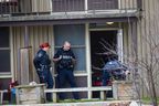 A Woodstock police officer and two members of Waterloo regional police collect evidence in an apartment unit at a housing complex at 161 Fyfe Ave. in Woodstock on Tuesday, Nov. 29, 2022. A man died following a dispute at the apartment early Tuesday, police said. (Calvi Leon/The London Free Press)