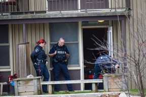 A Woodstock police officer and two Waterloo regional police officers collect evidence at an apartment unit at a housing complex at 161 Fyfe Ave.  in Woodstock on Tuesday, Nov. 29, 2022. A man died following a dispute at the apartment early Tuesday, police said.  (Calvi Leon/The London Free Press)