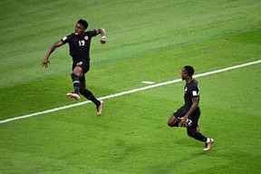 Alphonso Davies of Canada celebrates after scoring their team's first goal with their teammate Richie Laryea during the FIFA World Cup Qatar 2022 Group F match between Croatia and Canada at Khalifa International Stadium on November 27, 2022 in Doha, Qatar. (Photo by Stuart Franklin/Getty Images)