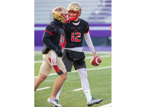 Laval Rouge et Or quarterbacks Xavier Tremblay (left) and Arnaud Desjardins share a laugh during practice at Western Alumni Stadium in London on Tuesday November 22, 2022. Derek Ruttan/The London Free Press