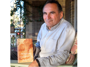 Author Eli Baxter, with his book Aki-wayn-zih at his home in London. 
Photograph taken on Monday November 21, 2022. 
Mike Hensen/The London Free Press/Postmedia Network