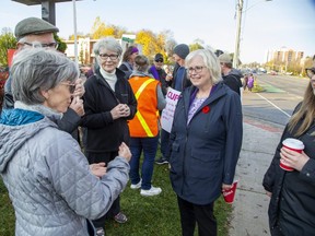 London West NDP MPP Peggy Sattler, right, speaks with some of the hundreds of education workers and their supporters picketing outside of her constituency office in London on Friday, Nov. 4, 2022. (Derek Ruttan/The London Free Press)