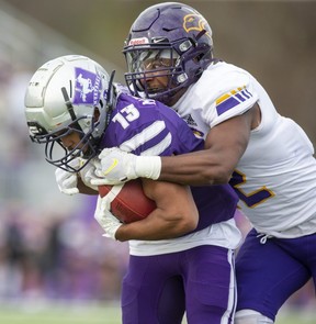 Laurier Golden Hawks defensive back Patrick Burke Jr. jumps over Western Mustang wide receiver Savaughn Magnaye-Jones during their OUA football semi-final at the Western Alumni Stadium in London on Saturday November 5, 2022. The Mustangs qualified for the next week's Yates Cup final with a 45-9 victory.  (Derek Ruttan/The London Free Press)