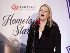 Laura Nielsen sings the national anthem at a  celebration for Damian Warner in London, Ont. on Monday, Nov. 14, 2022. Western University's student council has decided not so play O Canada to start its meetings. (Derek Ruttan/The London Free Press)