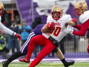 Laval Rouge et Or ball carrier Alex Duff is tackled by  Western Mustang Hugo Larue during the Mitchell Bowl at Alumni Stadium in London, Ont. on Saturday November 19, 2022. Laval won the game 27-20. (Derek Ruttan/The London Free Press)