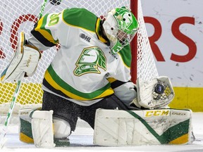 Brett Brochu of the London Knights watches an Erie Otter shot into his glove in a game Nov. 4, 2022, at Budweiser Gardens in London.  (Mike Hensen/The London Free Press)