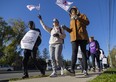 Striking education workers with the Canadian Union of Public Employees (CUPE) walk a picket line on Commissioners Road near Wharncliffe Road in London on Monday, Nov. 7, 2022, the second day their walkout had shuttered most schools here and provincewide. Mike Hensen/The London Free Press