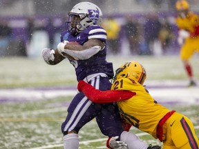 Western Mustangs running back Keon Edwards nearly outruns Eric Colonna of the Queen’s Gaels before finally getting hauled down during a snowy Yates Cup at Alumni Stadium in London on Saturday Nov. 12, 2022. Edwards was named MVP of the game, which Western won 44-16. (Mike Hensen/The London Free Press)